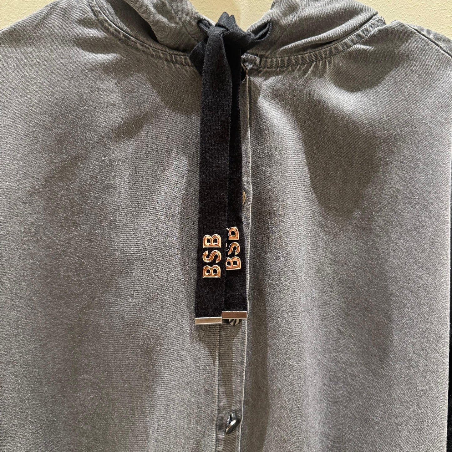 Chaqueta ligera gris con botones y capucha